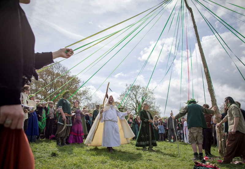 A Beltane festival with a maypole